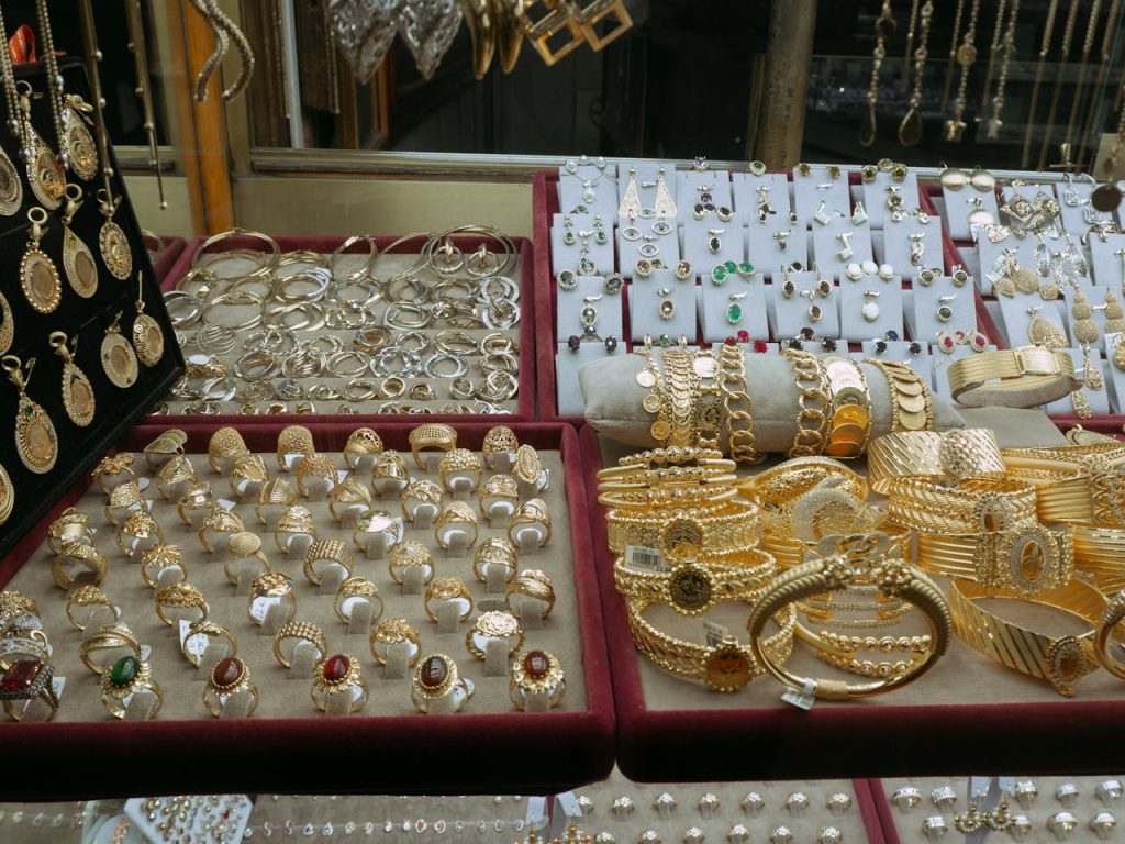 Showcase of elegant gold and silver jewelry in an Istanbul markets display case.